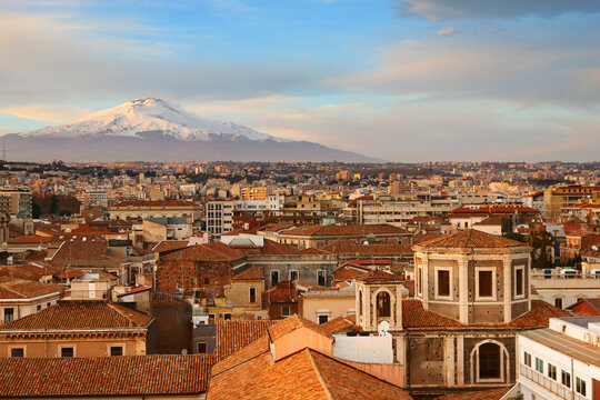 View of city Catania and Etna volcano at sunset in Sicily, Italy
