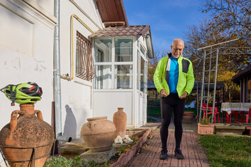 Old man exercising by riding a bicycle on a beautiful autumn day