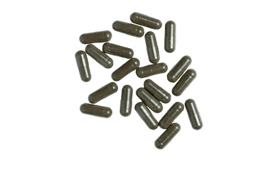 Herbal supplement capsules scattered on transparent background
