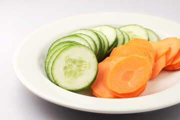 Yummy healthy Carrot and Cucumber salad served in white ceramic plate