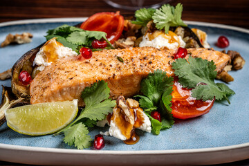 Close-up of grilled salmon with herbs and vegetables