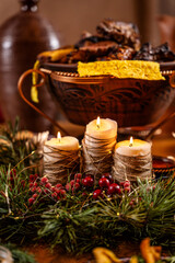 Festive candles and holiday table decor with warm rustic atmosphere