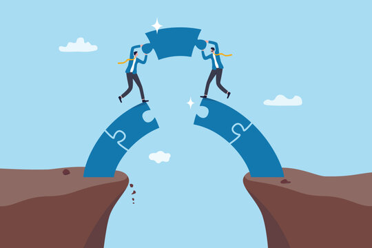 Connect the path to success together, teamwork or partnership, bridging the gap, collaboration or cooperation for winning challenge, businessman connect jigsaw puzzle as the bridge to connect the gap.