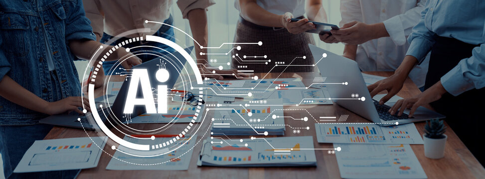 Diverse professionals collaborate in an office setting, engaging with AI-driven data visualizations on a table filled with documents, charts, and technology. Trope