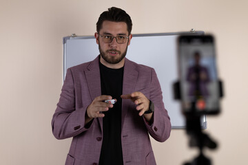 The man is recording a video for his blog