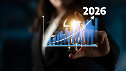 A focused businesswoman presenting a light bulb in front of a dynamic growth chart, symbolizing innovation, strategic planning, and future success in business environments. Tessel