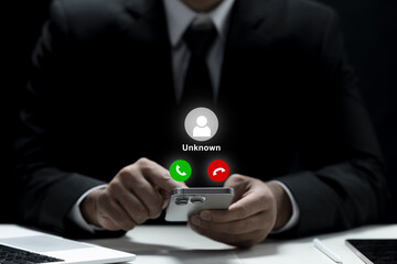 Businessman holding a cellphone with an unknown incoming call displayed on the screen. Concept of scam or phishing