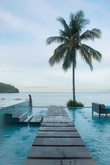 tropical beach with wooden jetty