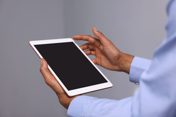 African-american man using tablet in office, closeup