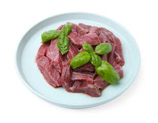Pieces of raw beef meat and basil isolated on white
