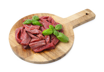 Pieces of raw beef meat and basil isolated on white