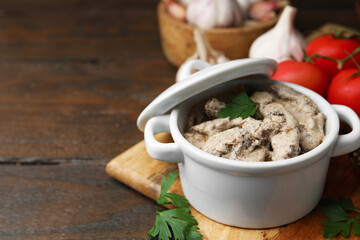 Tasty beef stroganoff with parsley served on wooden table, closeup. Space for text