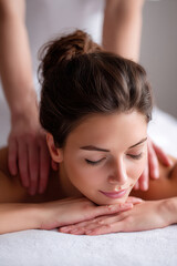 Fototapeta premium Relaxation therapy session with a woman receiving a massage in a calm indoor setting