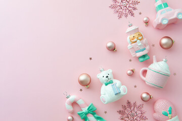 Flat lay pastel Christmas ornaments creating a festive bottom border on a pink background. Cute, shabby chic style.