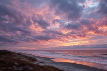 Obraz premium Silhouetted Shore at Dusk Under Halos of Orange and Purple Clouds