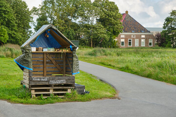 A selfservice roadside stand near a farm in Friesland The Netherlands selling potatoes and onions.