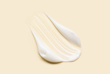 Obraz premium Close-up of cosmetic cream smear, smooth and shiny texture, pastel background
