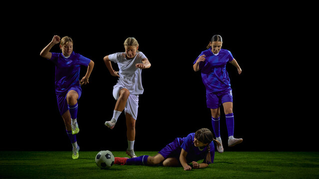 Teenage soccer players chasing ball with one teammate on ground in active play. Concept of youth dynamic drills, competitive analysis, training materials, tactical communication.