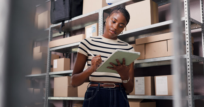 Shipping, tablet and stylus with black woman in warehouse for inspection, ecommerce or supply chain. Online checklist, quality assurance or inventory manager with low angle of person for distribution - Powered by Adobe