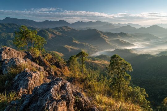 Sunbeams over rolling hills from the summit of Phou Fa, Phongsaly, Laos at dawn