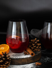 Mulled wine with citrus and spices in rustic winter setting