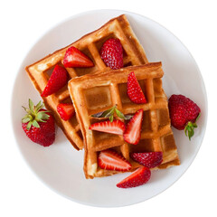 Golden brown waffles topped with fresh strawberries on a white plate