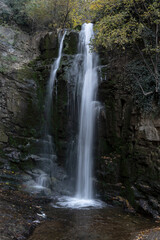 Serene Waterfall Cascading Through a Rocky Cliffside