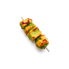 A succulent and freshly grilled green kebab, with a vibrant green hue, placed against a clean and pristine white background