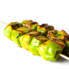 A succulent and freshly grilled green kebab, with a vibrant green hue, placed against a clean and pristine white background
