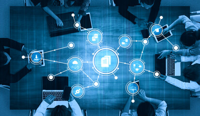 A diverse team collaborates in a modern office, utilizing digital tools and data visualization to brainstorm and create innovative strategies for project success. Tessel