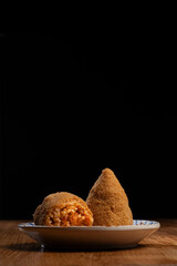Two Sicilian Arancini Street Food: One Cut Open Showing Ragu Meat Sauce and Rice Filling