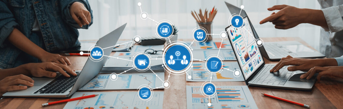 Panorama shot analyst team utilizing BI Fintech to analyze financial report with laptop. Businesspeople analyzing BI power dashboard displayed on laptop screen for business insight. Scrutinize Amity