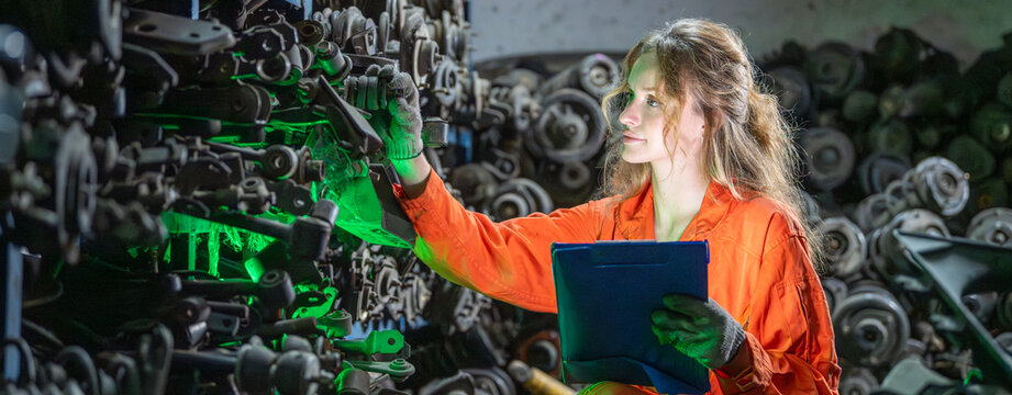 female worker checklist recycling auto parts in sustainable repair industry Worker sorting used mechanical components for reuse. technician assessment inspection secondhand recycled materials