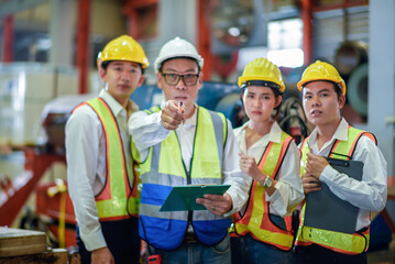 Header mentor and young employees trainee stand for operating machine looking see through camera...