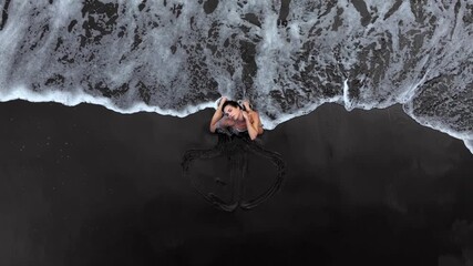 A woman in the water, surrounded by waves, expresses emotions, a serene moment and flowing water.