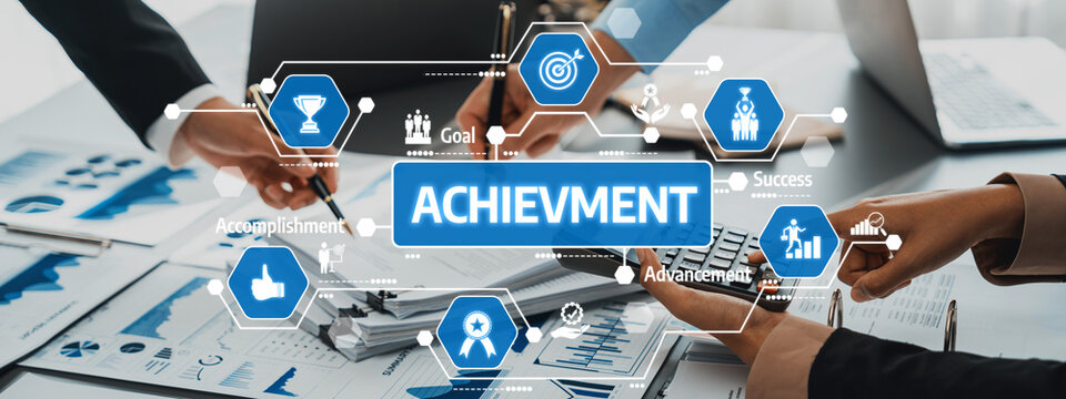This image showcases hands engaging in a collaborative business setting focused on achievement, featuring charts and digital symbols representing success and goals. Amity