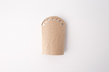 Simple cardboard tube with punched holes, useful for sustainability marketing, packaging design, DIY blogs, early childhood education, eco product visuals, waste reduction campaigns, craft tutorials.