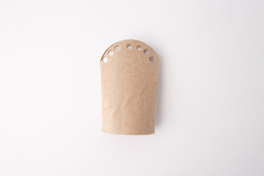 Simple cardboard tube with punched holes, useful for sustainability marketing, packaging design, DIY blogs, early childhood education, eco product visuals, waste reduction campaigns, craft tutorials.