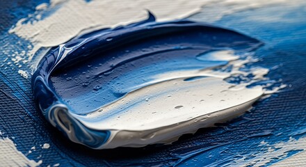 Close-up of vibrant blue and white oil paint strokes on canvas, showcasing rich texture and artistic detail.