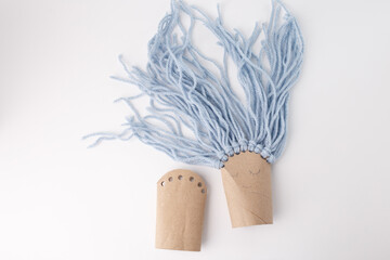 Whimsical handmade doll from recycled cardboard and yarn, ideal for eco-friendly brands, craft...