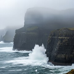 Dramatic Waves Crashing Against the Cliffs of Moher on a Foggy Day in Ireland.