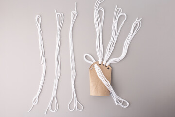 DIY yarn threading activity on cardboard, ideal for craft tutorials, educational content, toy design, preschool marketing, or handmade product branding.