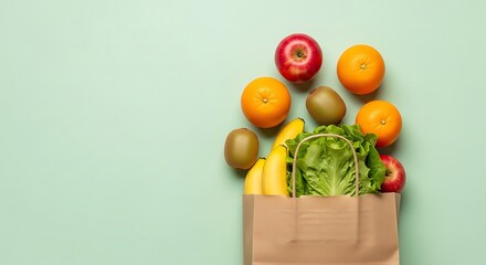 Fresh fruits and vegetables spilling from a brown paper grocery bag on a light green background, top view.