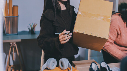 Asian woman describe selling clothes on camera live broadcast on social network at home, Online selling clothes on social media. Blogger woman influencer, SME retail store owner.