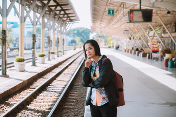 A backpacking tourist girl at the train station