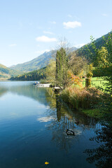 Fototapeta premium Autumn mountain landscape, mountains near lake, reflections in the water.