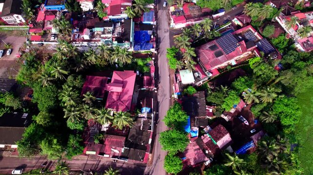Coastal village with parking and colva beach. day time, tilt up shot, drone shot, 4k.