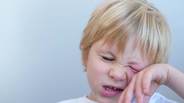 close up little boy with allergic red spot at face cause by mosquito bite