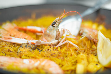 Spanish seafood paella, giant prawns on noodles, made with an original recipe in Valencia