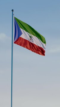 Equatorial Guinea, Malabo: Cinematic Vertical Waving National Flag Against Blue Sky